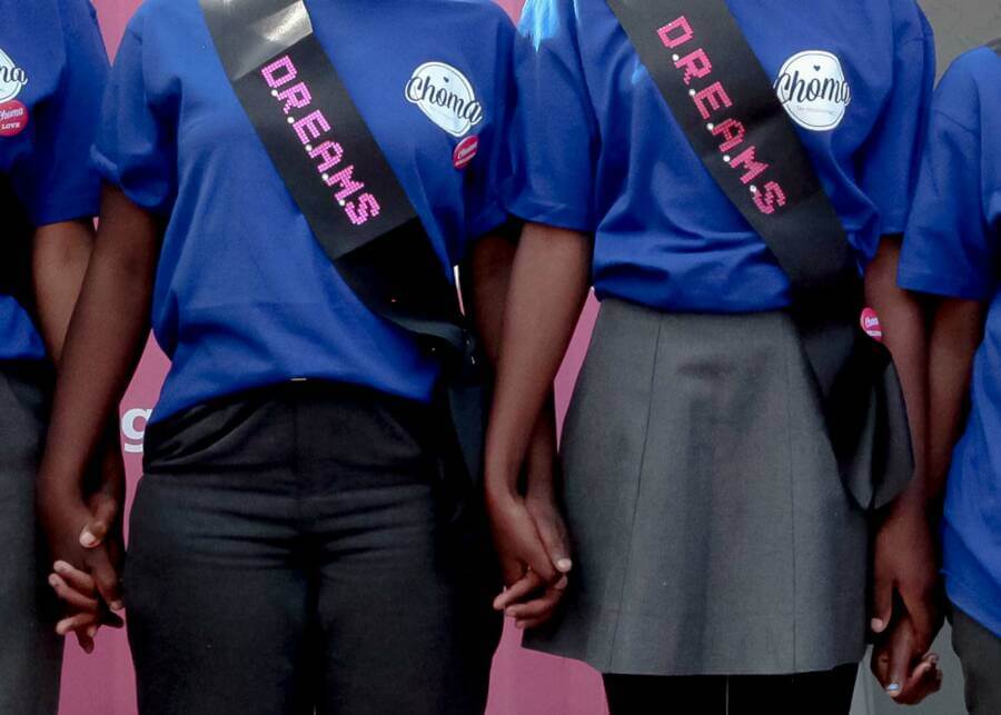 young people holding hands and wearing shirts with the Choma logo